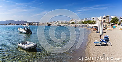 Boats and umbrellas in Haraki beach â€“ sunny day Rhodes, Greec Stock Photo